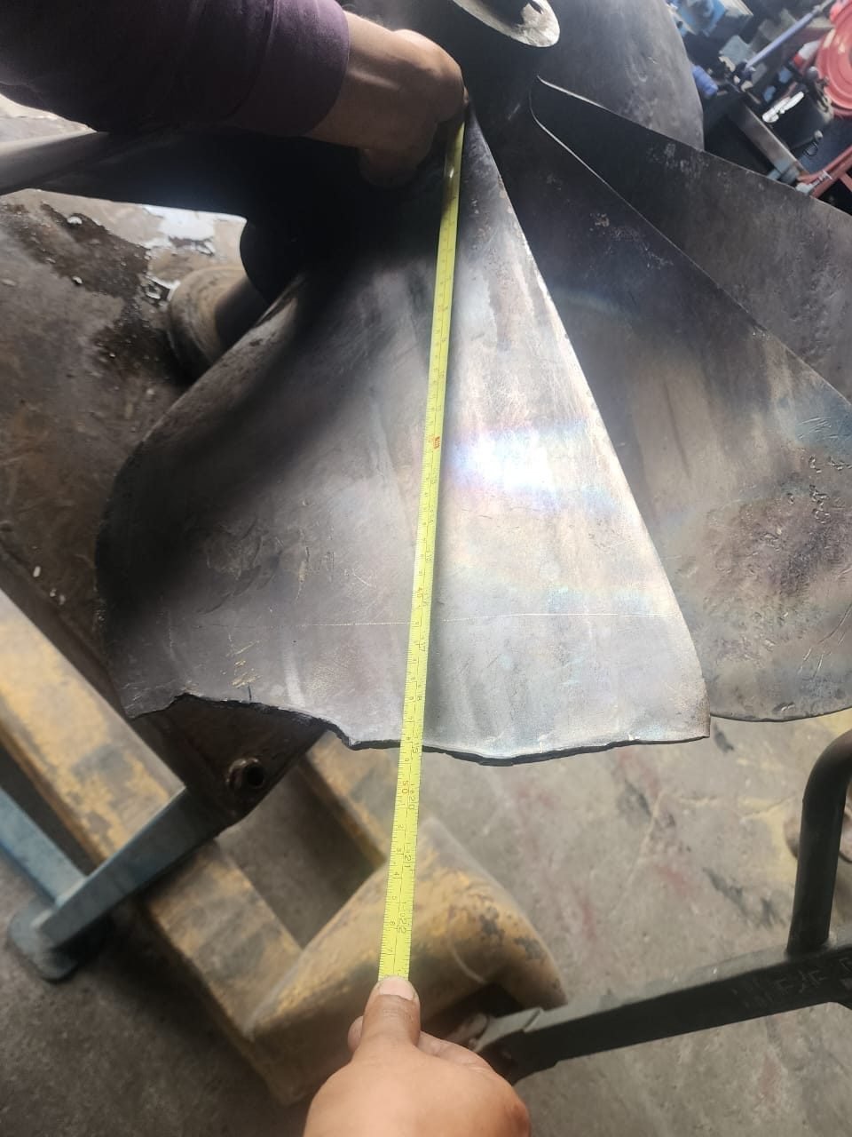 Measuring a propeller blade during repair