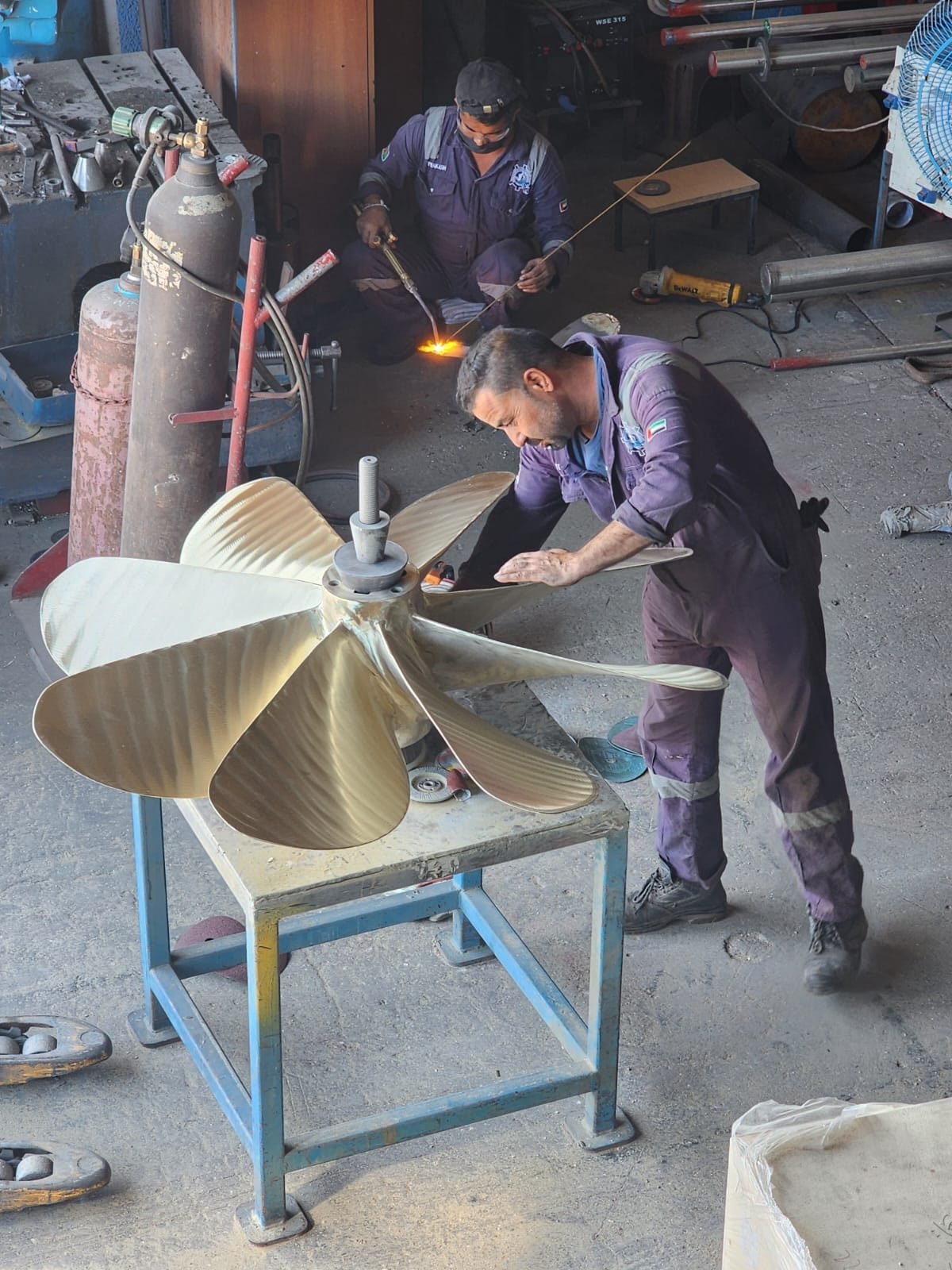 Technician working on a five-blade propeller in the workshop