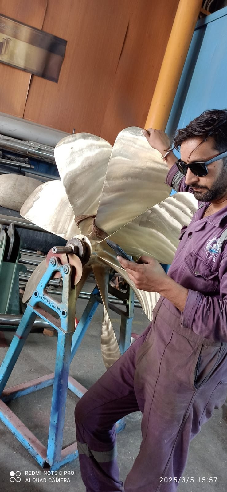 Technician with a repaired propeller in the workshop
