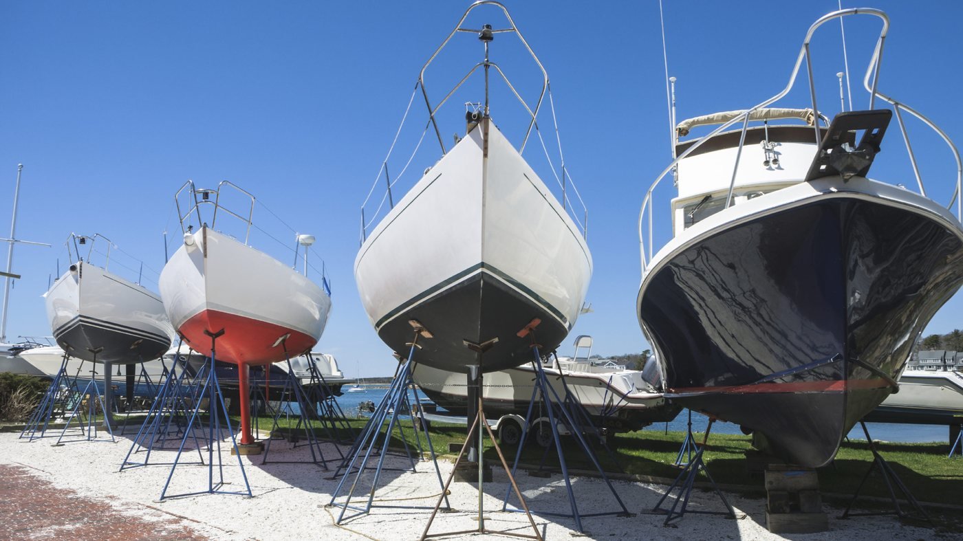 Boats out of the water on stands in a boatyard